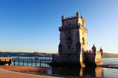 Belem tower by river against sky