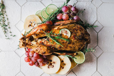 Duck poached for thanksgiving with grapes, quince, rosemary and thyme