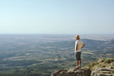 Rear view of woman standing on landscape