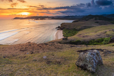 Scenic view of beach against sky during sunset