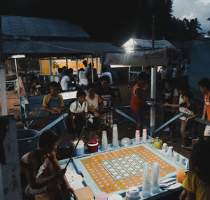 High angle view of people at illuminated market