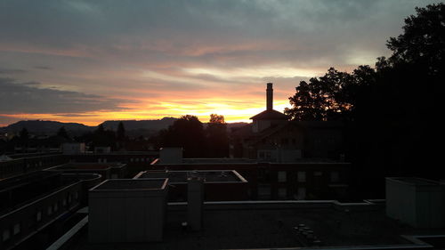 City against sky at sunset