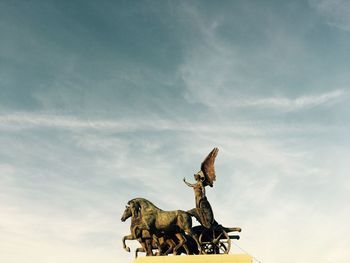 Low angle view of horse sculpture against sky