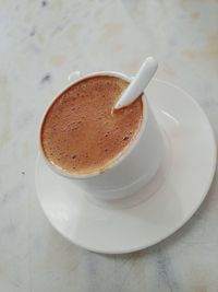 High angle view of coffee cup on table