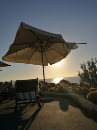 Traditional windmill on beach against clear sky