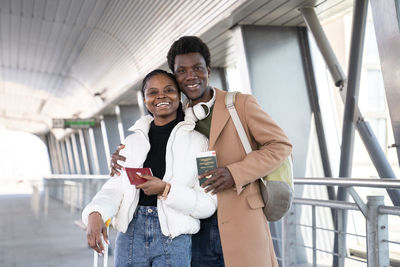 Portrait of smiling couple standing at airport