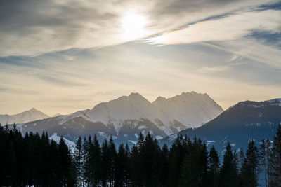 Scenic view of snowcapped mountains against sky during sunset