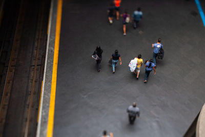 High angle view of people walking on road