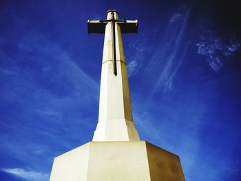 Low angle view of statue against blue sky