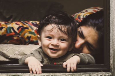 Portrait of cute smiling boy on bed