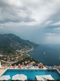 High angle view of swimming pool by buildings against sky