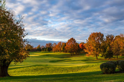 Scenic view of golf course against sky