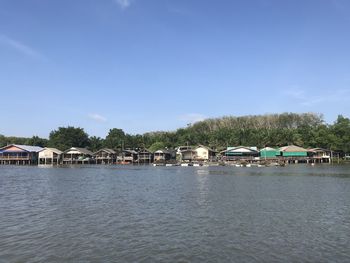 Scenic view of lake by building against sky