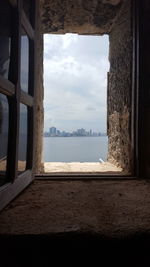 View of sea seen through window