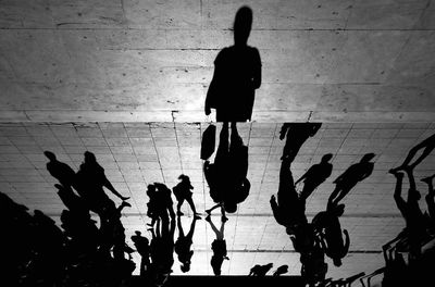 Silhouette people hanging on floor