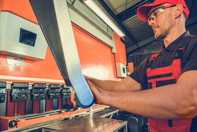 Midsection of man working in workshop