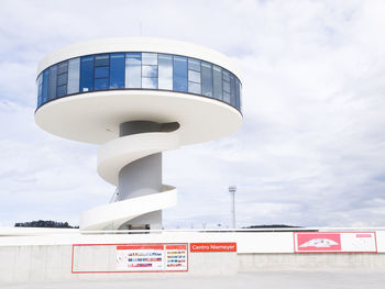 Low angle view of information sign against sky