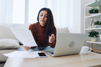 Portrait of woman using laptop at home