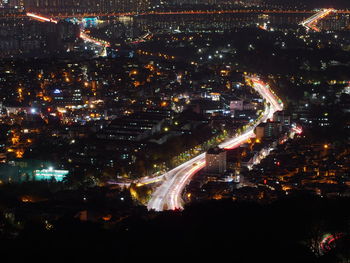 High angle view of city lit up at night