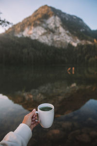 Cropped hand holding coffee