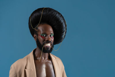 Low angle view of man against blue background