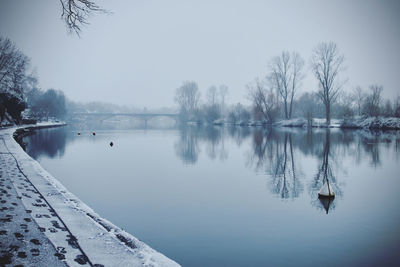 Scenic view of river against sky during winter