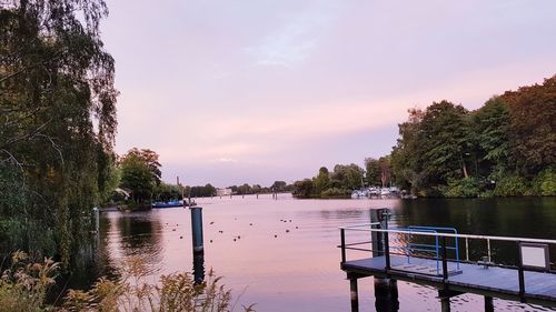 Scenic view of lake against sky at sunset