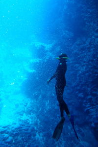 Cave diving silhouette in blue waters of vava'u, tonga