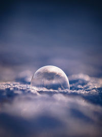 Close-up of moon over sea against sky