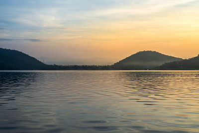 Scenic view of lake against sky during sunset