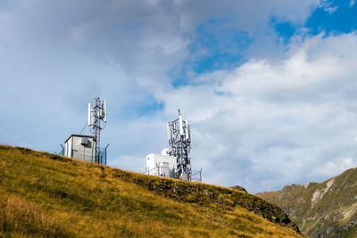 Low angle view of communications tower against sky