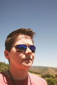 Woman wearing sunglasses against clear sky