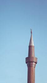 Low angle view of bell tower against clear blue sky