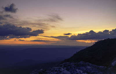 Scenic view of silhouette mountains against sky at sunset