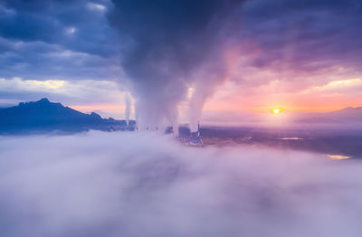 Aerial view coal power plant station in the morning mist, the morning sun rises. 