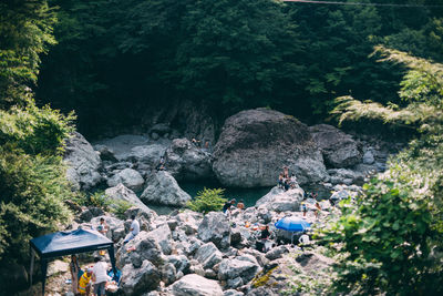 High angle view of people on rocks in forest