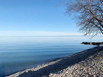 Scenic view of sea against clear blue sky