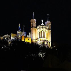 Low angle view of illuminated building at night