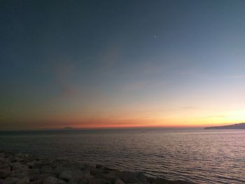 Scenic view of sea against sky at sunset