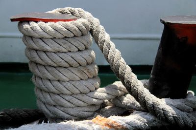 Close-up of rope tied on bollard