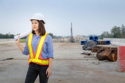 Woman wearing hat standing against sky