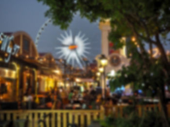 Close-up of illuminated ferris wheel at night