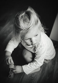 High angle view of cute girl sitting at home