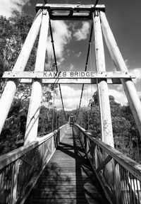 Empty footbridge against sky