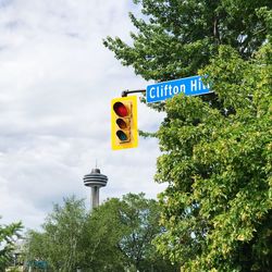 Low angle view of road sign against sky