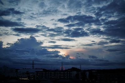 Clouds over city at sunset