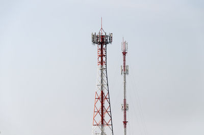 Low angle view of communication towers against clear sky