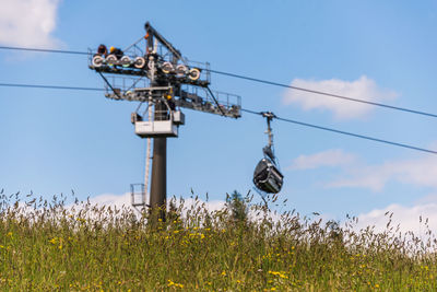 An alpine meadow and blurred technical support of the ski lift during the review and maintenance.