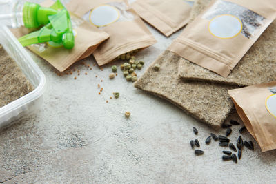 Microgreen seeds in paper bags and microgreen sowing equipment on the table. healthy food.