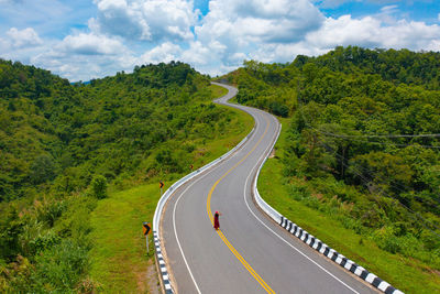 Road amidst trees against sky